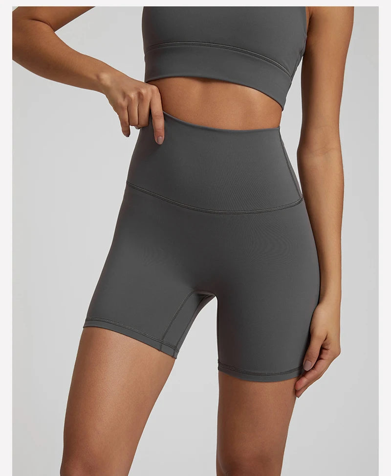 High-waisted, no front seam biker shorts for women, made from buttery-soft spandex. Perfect for gym workouts, yoga, and sports, offering comfort, support, and a flattering fit with 5-inch inseam.