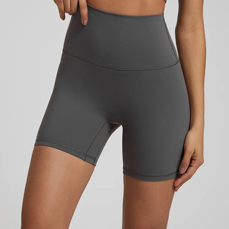 High-waisted, no front seam biker shorts for women, made from buttery-soft spandex. Perfect for gym workouts, yoga, and sports, offering comfort, support, and a flattering fit with 5-inch inseam.