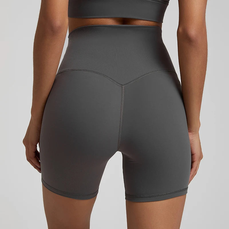 High-waisted, no front seam biker shorts for women, made from buttery-soft spandex. Perfect for gym workouts, yoga, and sports, offering comfort, support, and a flattering fit with 5-inch inseam.