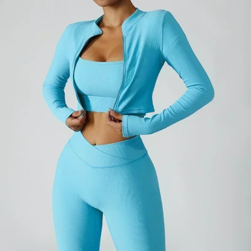 Women's 3-Piece Tracksuit Set featuring a stylish jacket, sports bra, and leggings. Designed for comfort and support, perfect for workouts, yoga, and gym training. The high-performance material offers a flattering fit, enhanced flexibility, and breathable fabric for maximum mobility and confidence during exercise. Ideal for fitness enthusiasts seeking a versatile, chic sportswear set.