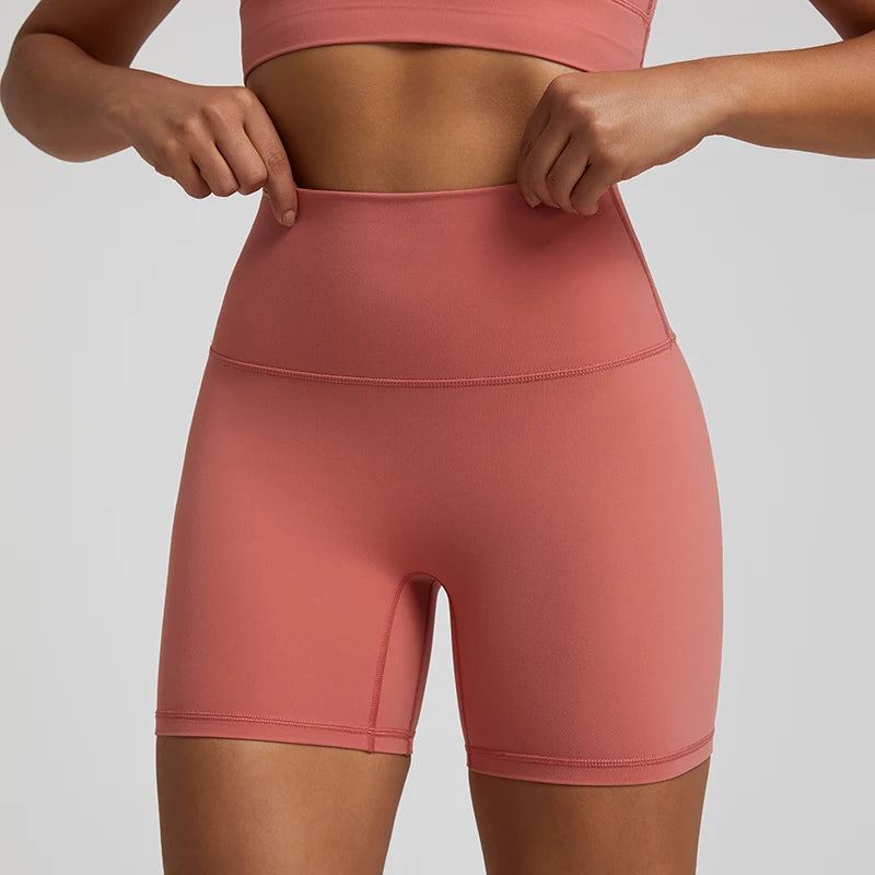 High-waisted, no front seam biker shorts for women, made from buttery-soft spandex. Perfect for gym workouts, yoga, and sports, offering comfort, support, and a flattering fit with 5-inch inseam.