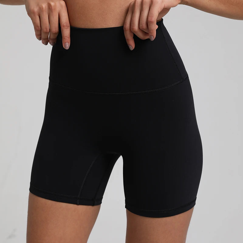 High-waisted, no front seam biker shorts for women, made from buttery-soft spandex. Perfect for gym workouts, yoga, and sports, offering comfort, support, and a flattering fit with 5-inch inseam.